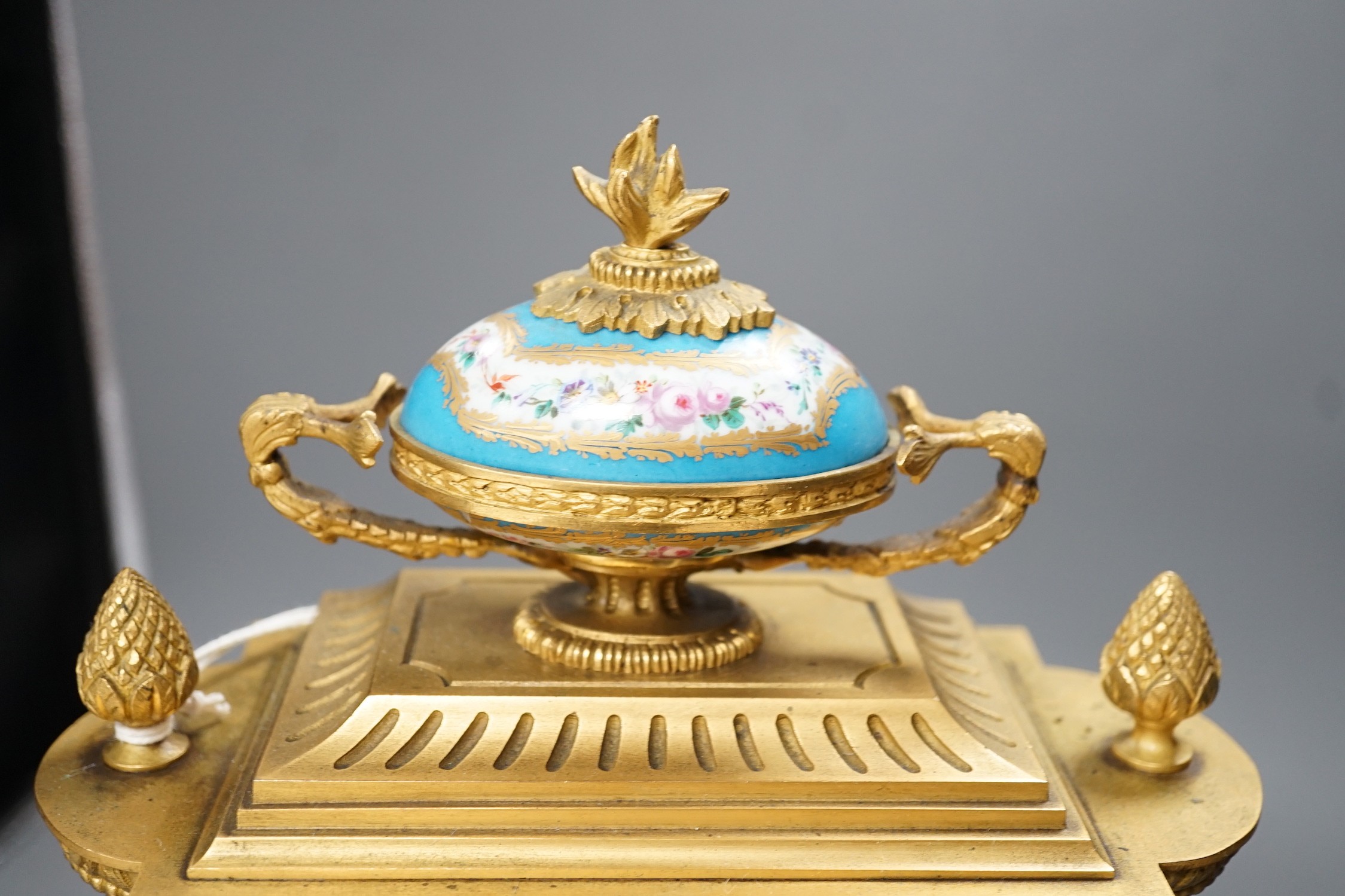 A French ormolu mantel clock, with inset floral decorated porcelain plaques and dial, 34cm high